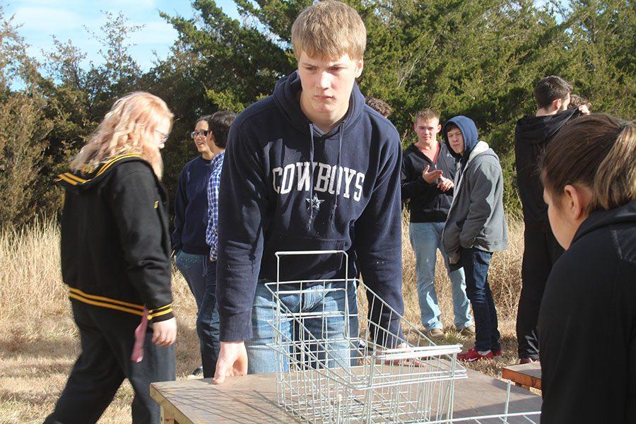 Sophomore Ethan Entz transports a farrowing crate during the renovation of the FFA facilities. 