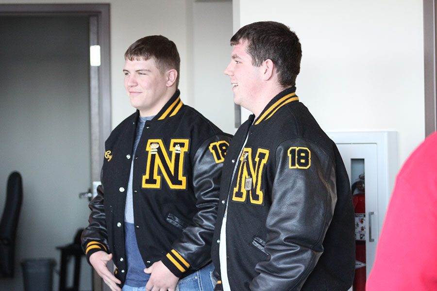 Junior Cyle Gautschi stands with a smile after his friend junior Jesse Rose presented him with a new letterman jacket.