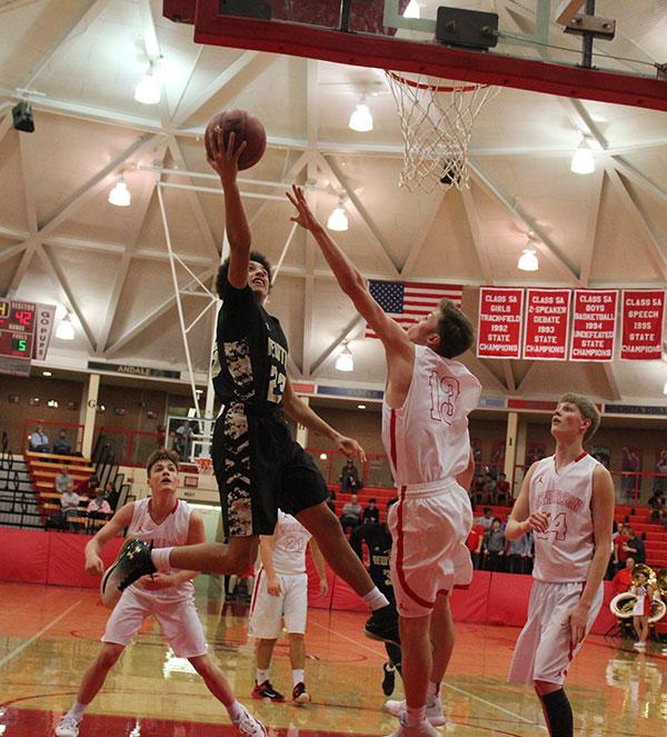 Freshman Ty Berry drives to the basket against a McPherson defender on Jan. 24. The final score was 63-65, McPherson.