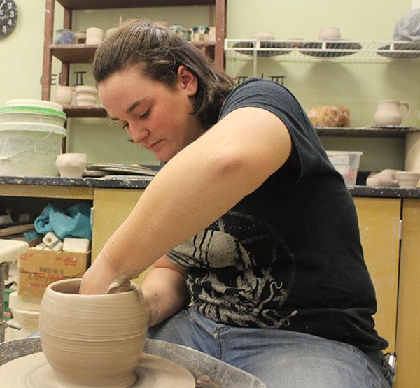 Molding+the+clay+into+a+vase%2C+senior+Kathleen+Smet+gets+her+hands+dirty+in+Ceramic+class.+This+class+involves+things+like+glazing%2C+clay+mixing%2C+and+kiln+firing.