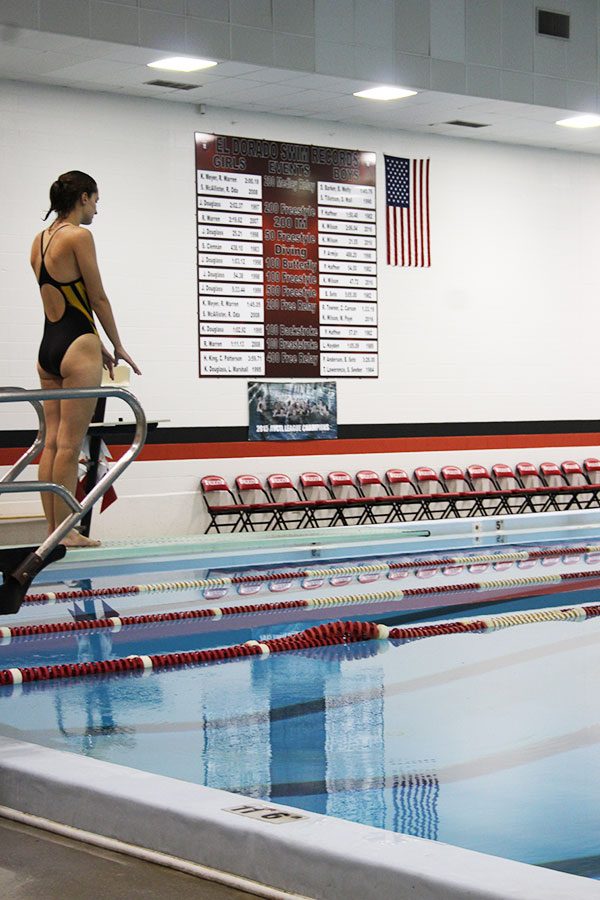 Preparing to dive, junior Naomi Kuhn counts her step in order to get her timing right.