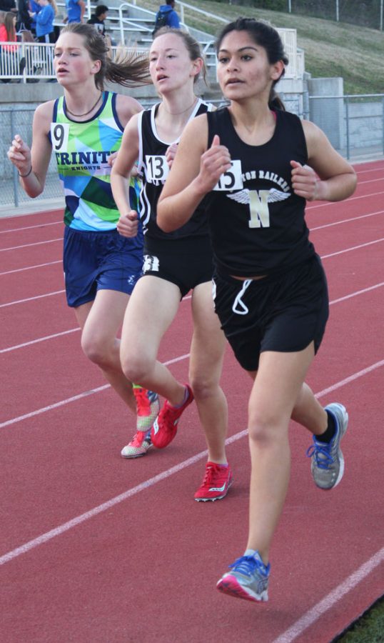 Rounding the 800 meter mark, senior Junuen Lujano battles her opponents during the 1600 meter race. Lujano crossed the finish line at 7:04.
