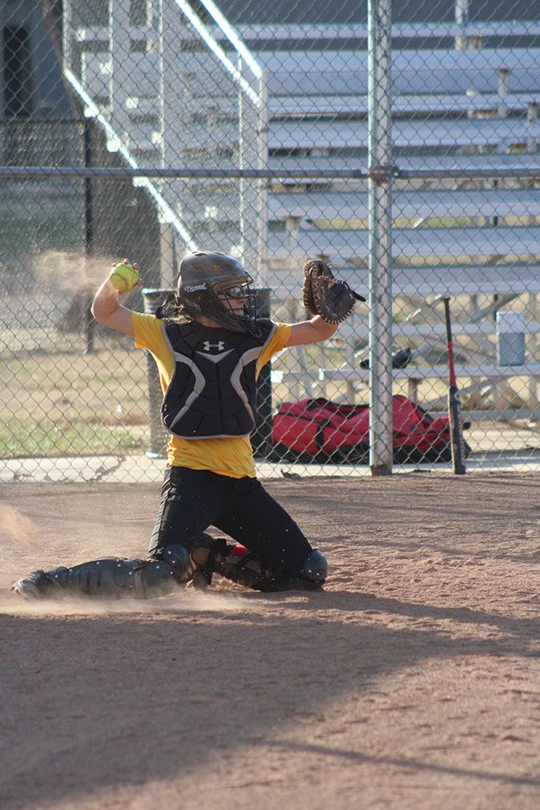 Senior Micheala Regier catches the strike and returns the ball to the pitcher. 