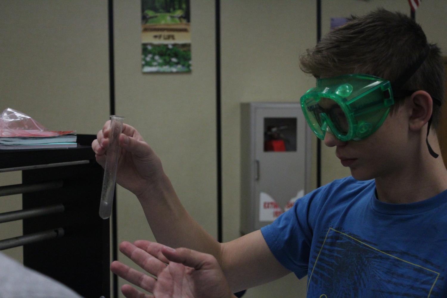 Focused sophomore James Tyrell watches the reaction of vomit lab searching for what is contained in the vomit.