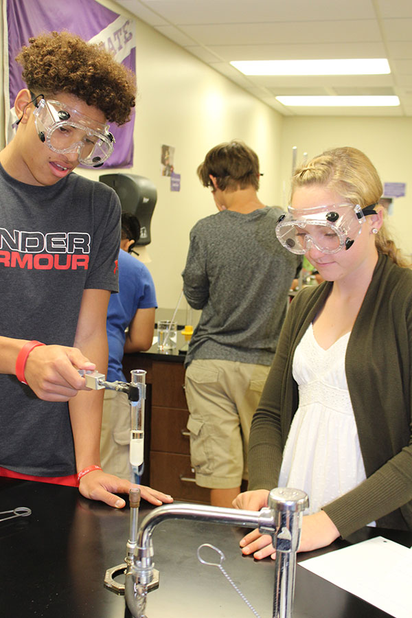On September 12, honors chem. 1 students participate in a lab. Zadi Simonsen and Ty Berry heat up a solid substance until it becomes a liquid.