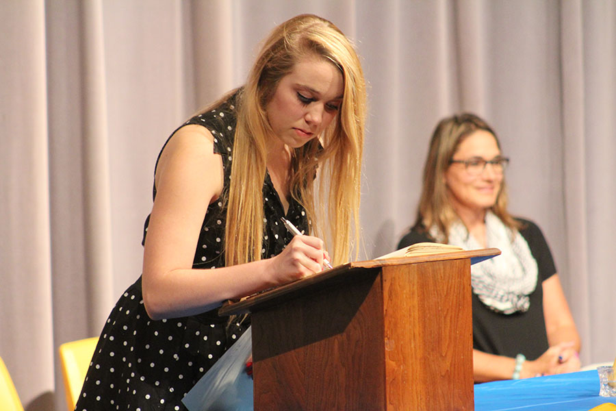 Junior Fallon Million marks her name in the NHS book, official adding herself as a member.