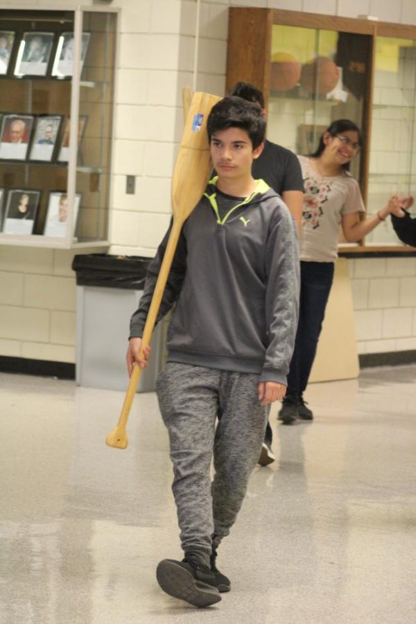 Ready to row down the hall, freshman Alex Velverda marches in step with the others performing their second big group dance. The boys participated in two huge group dances that night reviewing over all of their steps with Mrs. Olias. 