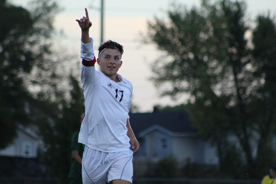 Senior Jose Rojas holds up a number one to celebrate his first goal of the game. The game took place at Fischer Field on September 21 against Salina South.  