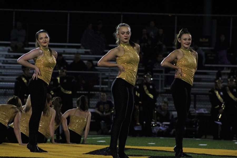 Putting on a show, seniors Macy Rice, Kate Szambecki, and Samantha Buffalo show sass as they perform their last railiner dance. The girls have been on the team for four years.
