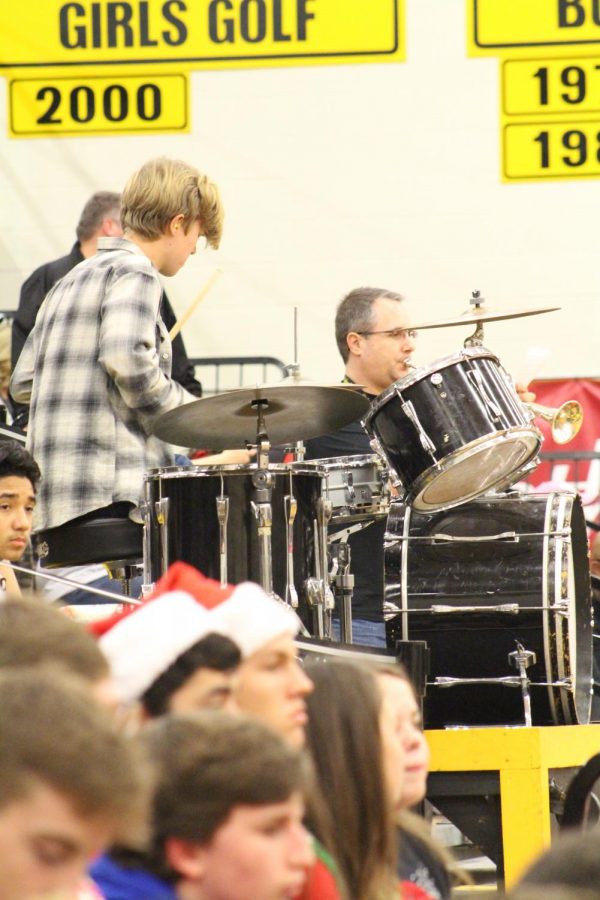 Junior Daniel Buller plays the drums alongside the pep band. Percussion band members rotate on and off the drum set. 