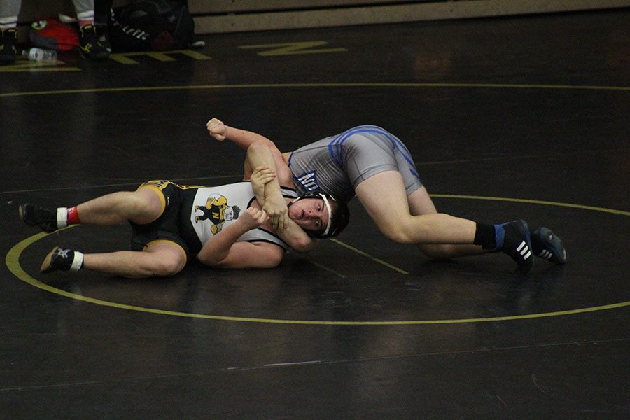 Senior Brayden Miller fights to stay in the match. Miller eventually fell to his opponent, but did not allow himself to be taken down easily.