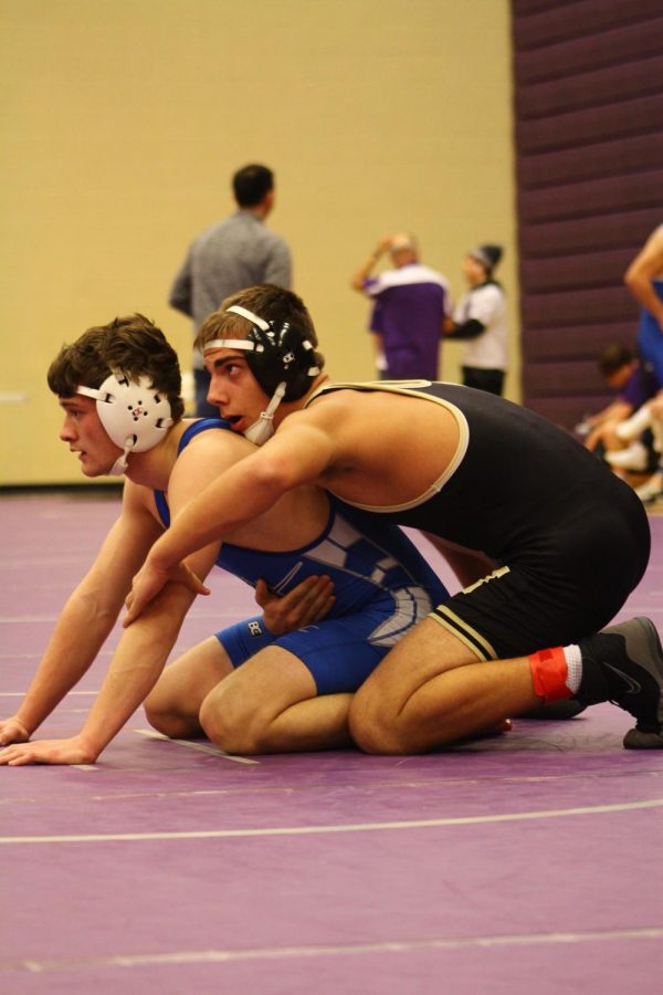Freshman Nicholas Antonowich watches the ref during his first match of the day.