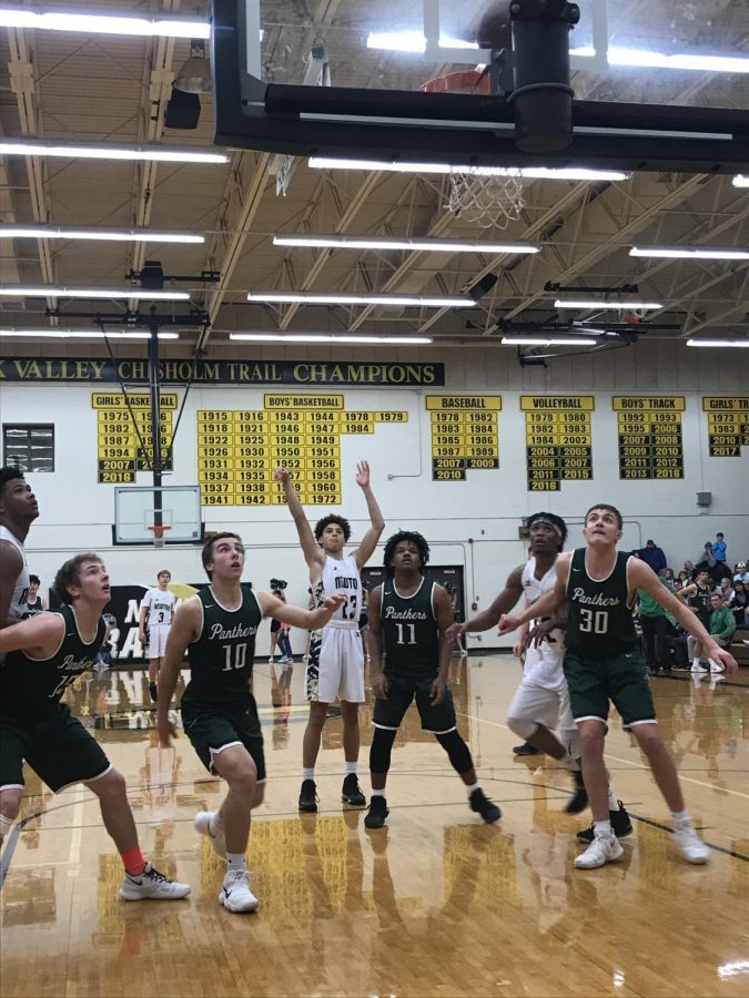 Sophomore Ty Berry sinks a free throw at the end of the 4th quarter to secure the win. Varsity boys won 68-65 against the Derby Panthers.