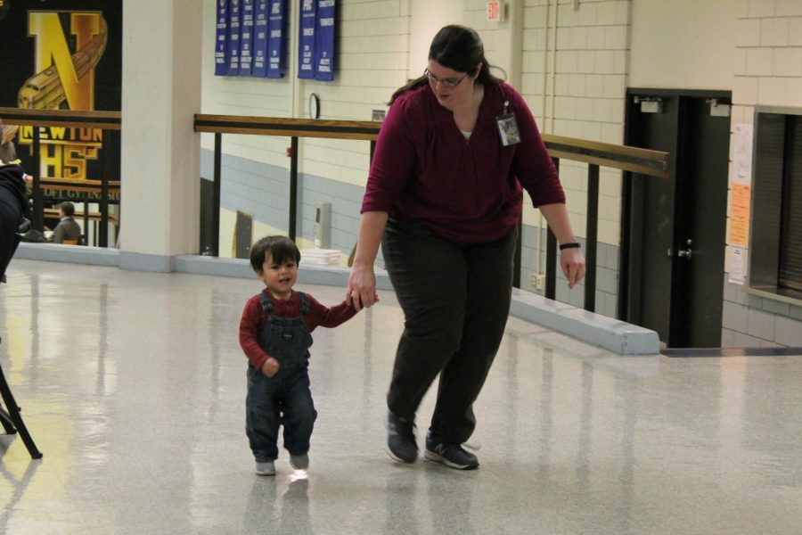 Burning off some energy, FACS teacher Molly Schauf runs through the halls with Kaete Schmidt’s son, Theo, during Schmidt’s parent teacher conference. Schauf is working with the Schmidt family to create a daycare to support teen moms while they are at school. “Anytime we would go to talk about ideas Theo would come. And then I was Ms. Schauffs teacher aide..so Theo and her have slowly gotten closer over time,” Schmidt said.