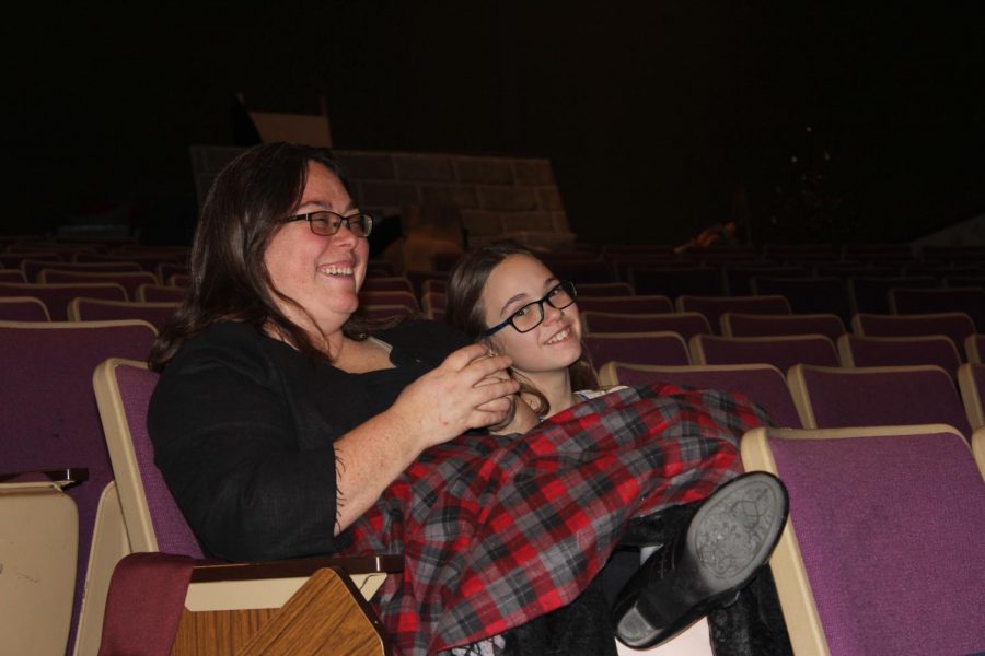 Math teacher Jennifer Horn sits with her daughter at rehearsals for Brigadoon. This year, district staff members were invited to participate in the production.