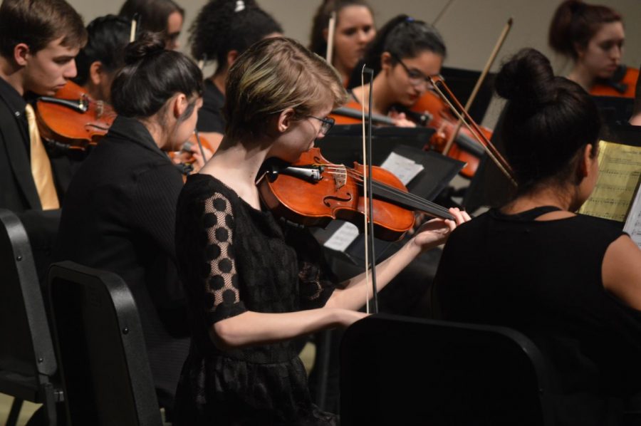 Freshman Acacia Penner plays during the concert. Freshmen orchestra went first that night.