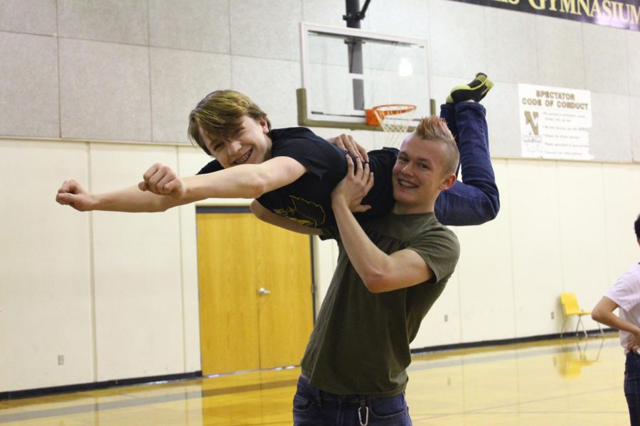 Posing for the camera, freshman Creed Ekerberg lifts freshman Jacob Phillips into the air. Ekerberg and Phillips learned multiple new dance moves in swing dance club.