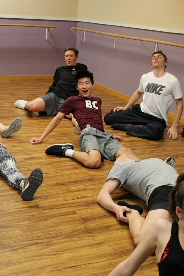 Seniors Jason Wong, Warren Dietz, Sport Tegethoff, and Elijah Boese stretch before they dance on Mar. 14. Each boys was paired with a junior or senior girl, with one sophomore.