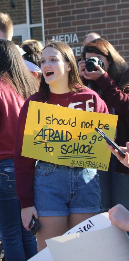 Chanting along Junior Emma Ellis rallies with the students while they show respect to those who have lost their lives in the school shootings. The student led rally were started by the students in Parkland, FL so they would be able to share their story across the states.