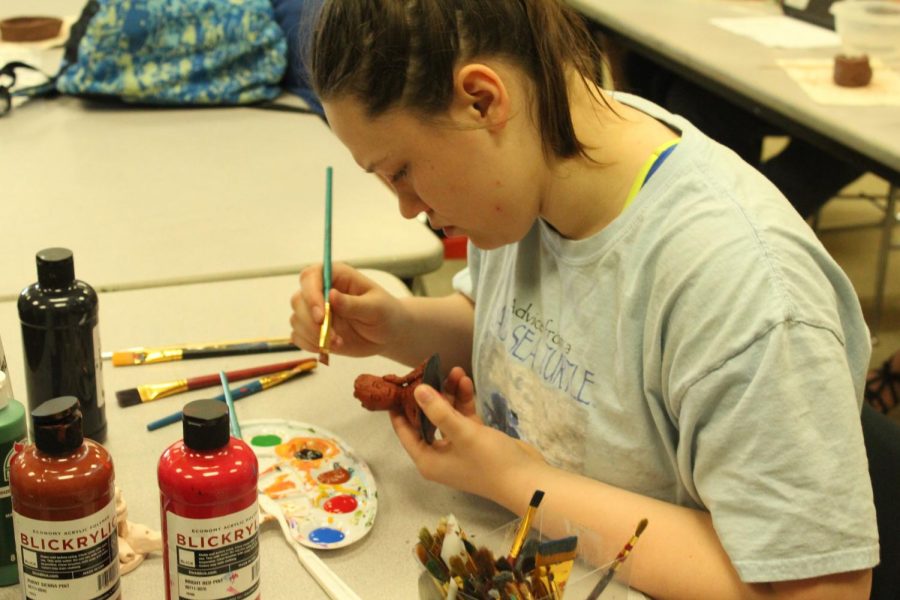 James concentrates as she tries to paint every detail on her clay figure. James chose Baby Groot as her piece. I just loved Baby Groot in Guardians of the Galaxy, James said.