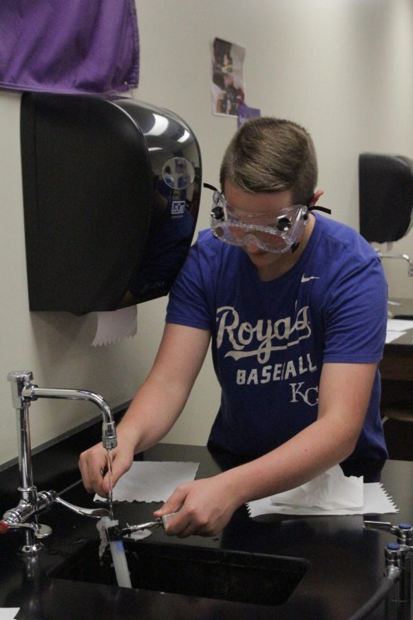 Cleaning out the test tube sophomore Josh Bergman returns his lab table to normal. 