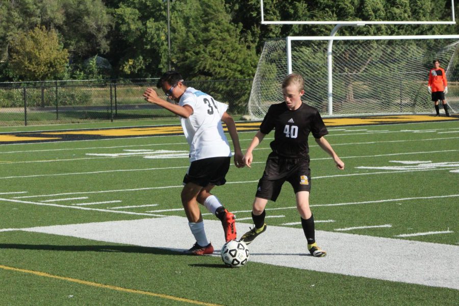 Freshman Benjamin Friesen Guhr defends against an outside wing player during their second home game against the Eisenhower Tigers on Sept. 20. 