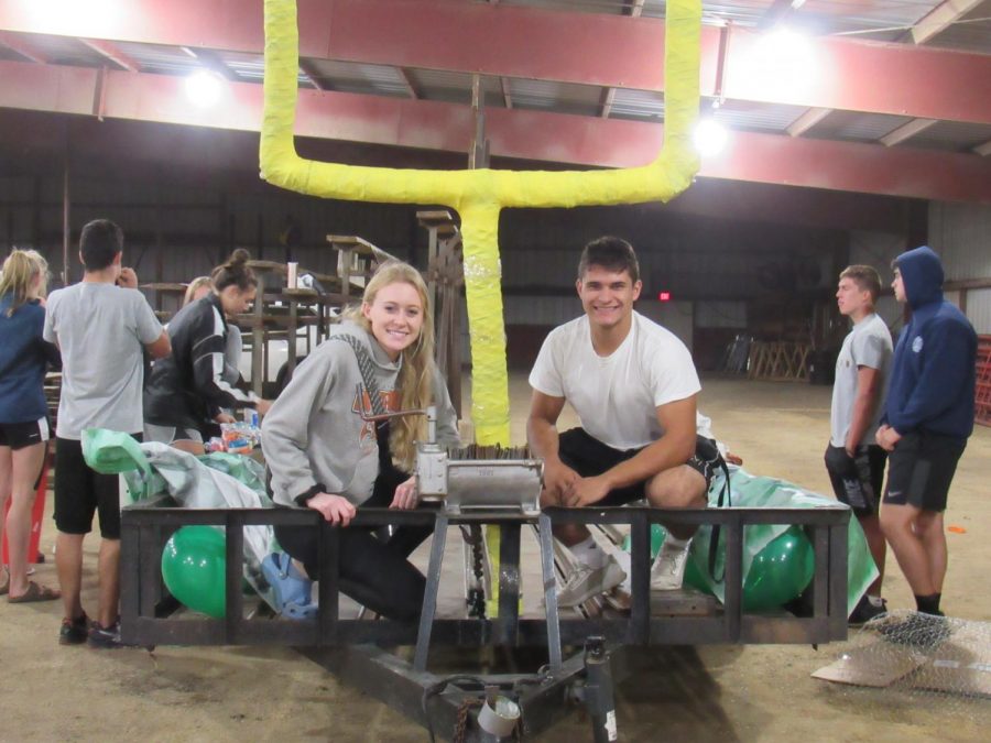 After hours of working, Seniors Aspen Olson and Matt Seirer pose in front of their finished product.