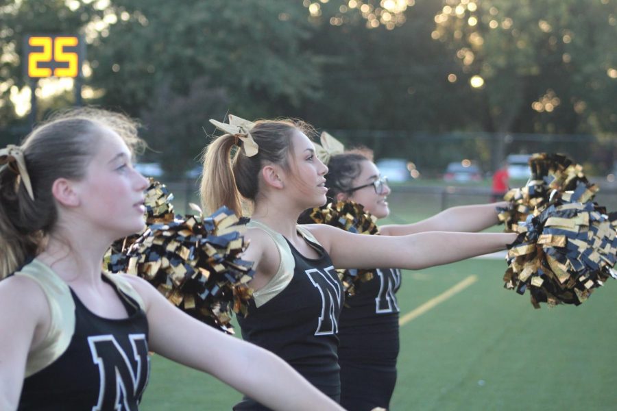 Freshman cheerleaders Jodie Masters, Jacey Yager, and Rylie Pierce cheer on the JV football boys. 