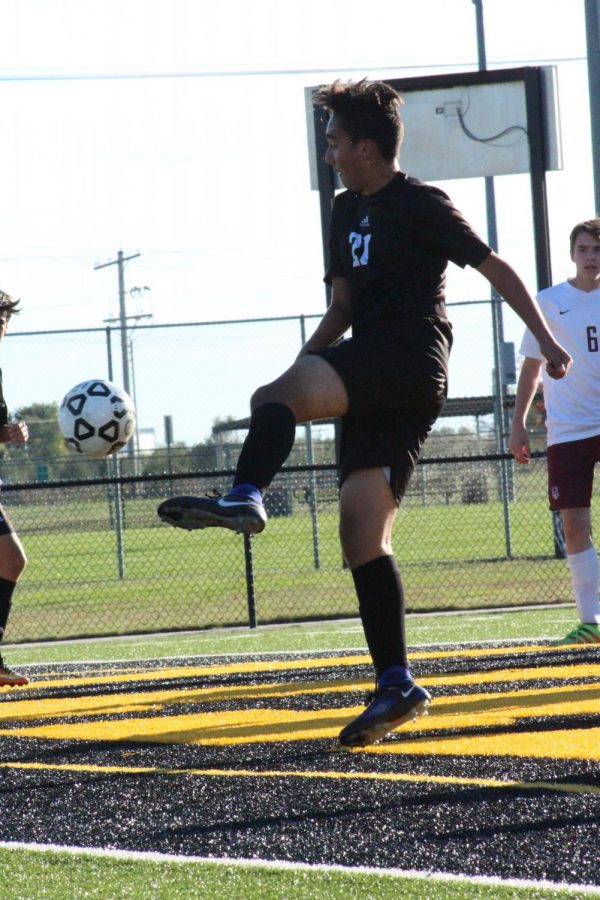 WIth his foot in the air, sophomore Gerardo Torres attempts to kick a goal.