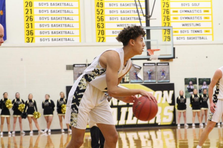 Making eye contact with a teammate, Ty Berry dribbles the ball during last year’s game against Haysville-Campus. Berry received his first Division I offer his freshman year from Kansas State University. 