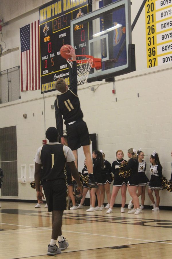 Warming up for the scrimmage, junior Alex Krogmeier goes up for a dunk.