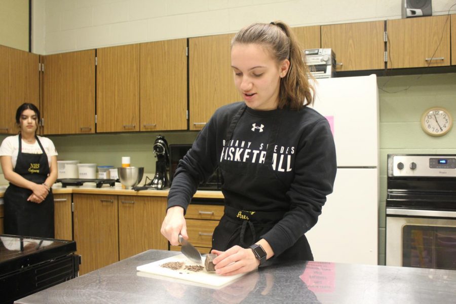 In place of chocolate chips, senior Megan Bartel cuts up chocolate.