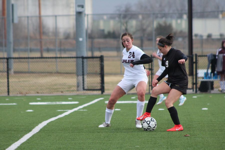 Sophomore Arianna Campos keeps the ball away from the Buhler defender.