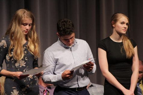Looking at his certificate, senior Matt Seirer stands in between seniors Claire Slechta and Katherine Sebes.