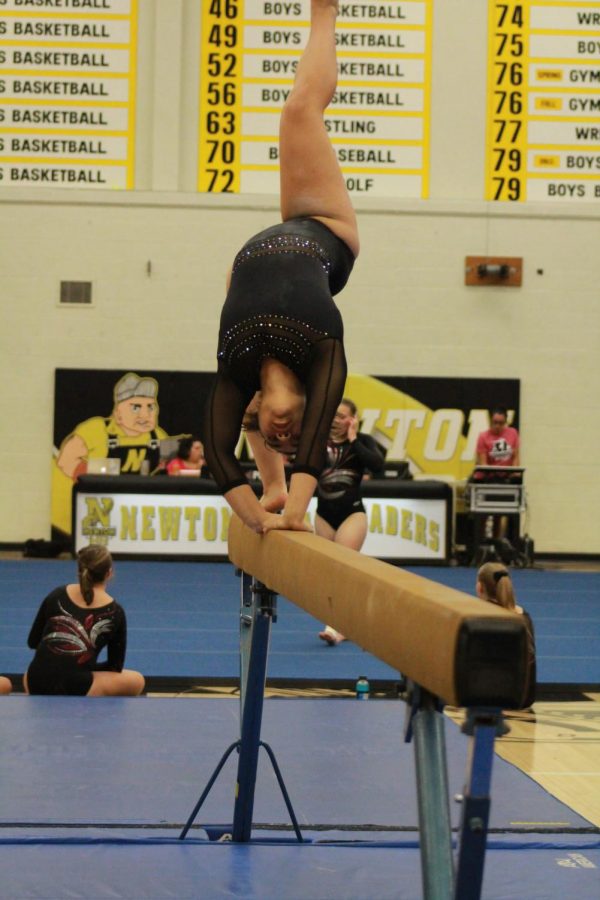 Keeping her balance. junior Toria Thaw comes out of a cartwheel.
