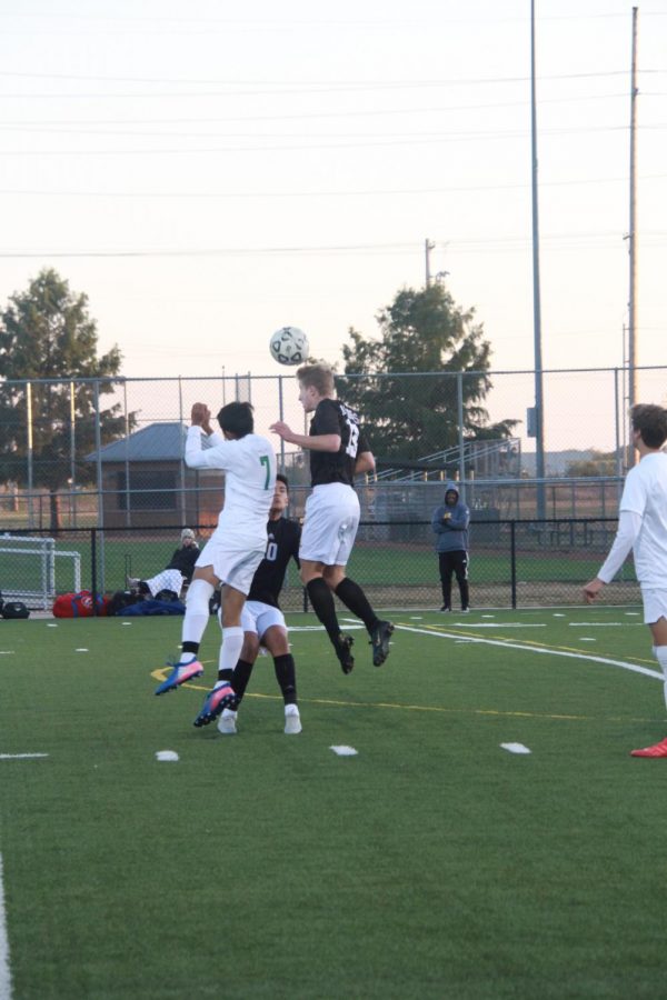In the air, freshman Collin Hershberger hits a header.