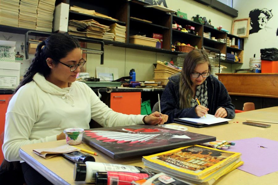 Junior Lourdes Moreno and Jewel Kelly work on their own personal art projects. 