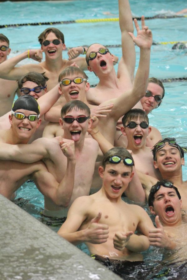 The boys swim team posing together before their second home meet. 