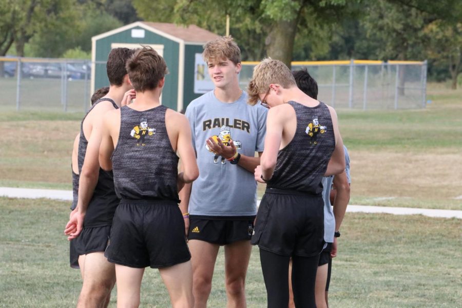 Senior+Luke+Schmidt+%28gray%29+talks+to+various+members+of+the+cross+country+team+at+the+Oct.+3+home+meet.