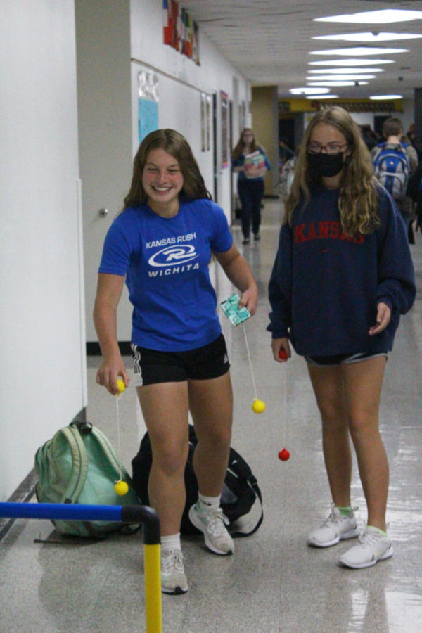 Freshmen Natalie Hershberger Margaret Oswald play a game of ladder toss by the P. E classroom. 