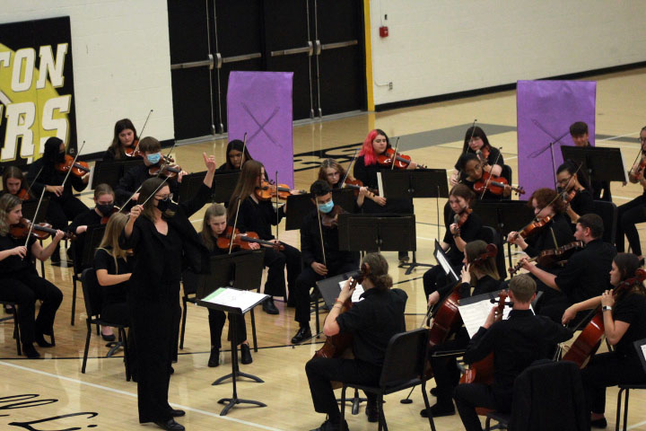 Staff+member+Rebecca+Schloneger+assists+the+NHS+Concert+Orchestra+while+they+play+Game+of+Thrones+with+the+NHS+Freshman+Orchestra.