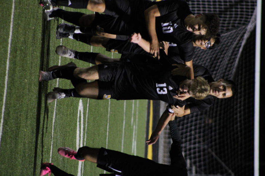 Members of the mens varsity soccer team celebrate Collin Hershberger scoring a goal against Salina South. The game ended 5-0 for a Newton win.