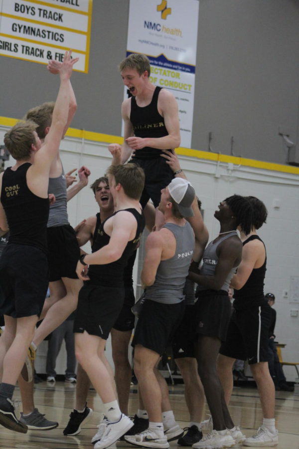 The Mailiners raise up senior Benjamin Friesen Guhr as a part of their performance. 