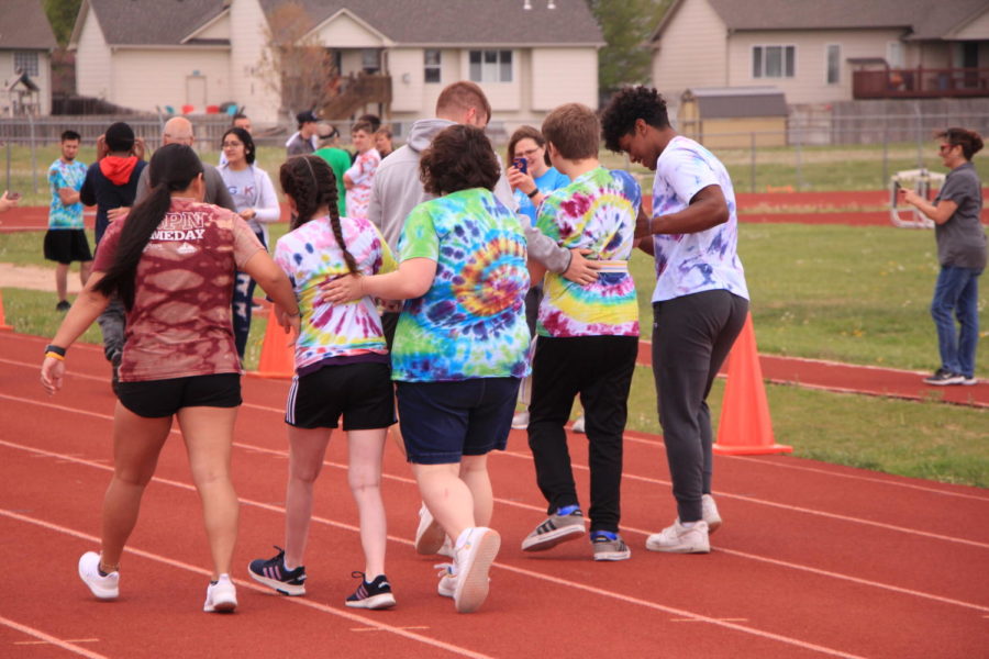 Student-athletes walk down the track with members of Jag-K on Apr 29.