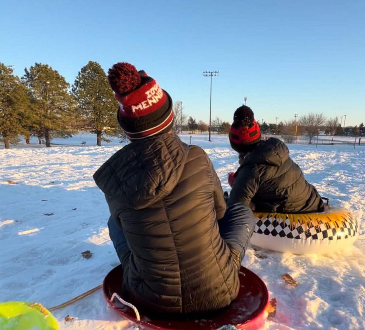 Juniors Regan Hirsh and Mara Oswald sledding down the Centennial Park Hill on one of the snow days.