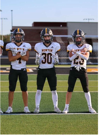 Rocco Ramos, Landyn Rains, and Joseph Sifuentez pose together before a game. 