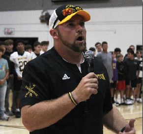 Coach Taylor Counts speaks to student body at the fall pep assembly. 