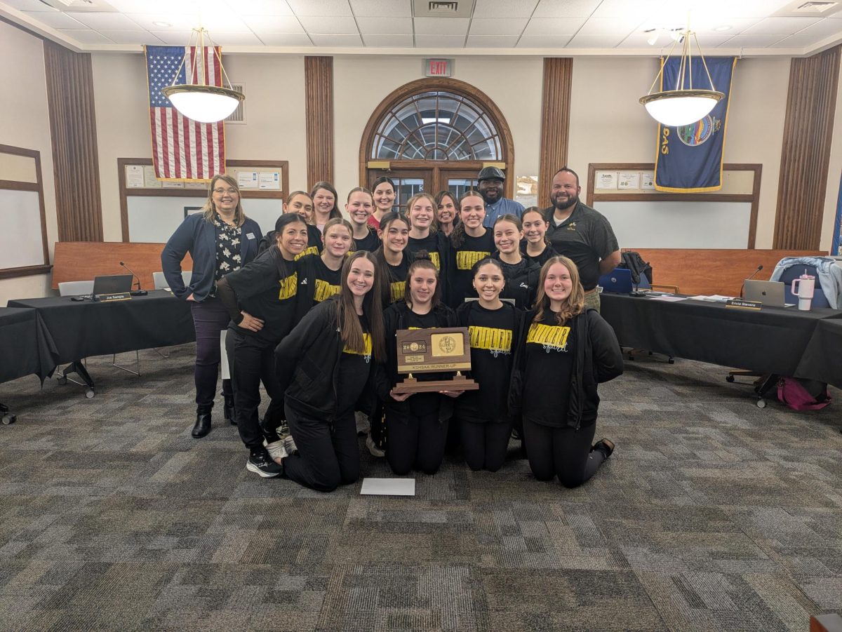 The Railiner dance team poses for a picture with BOE members after being recognized for their state placement. 