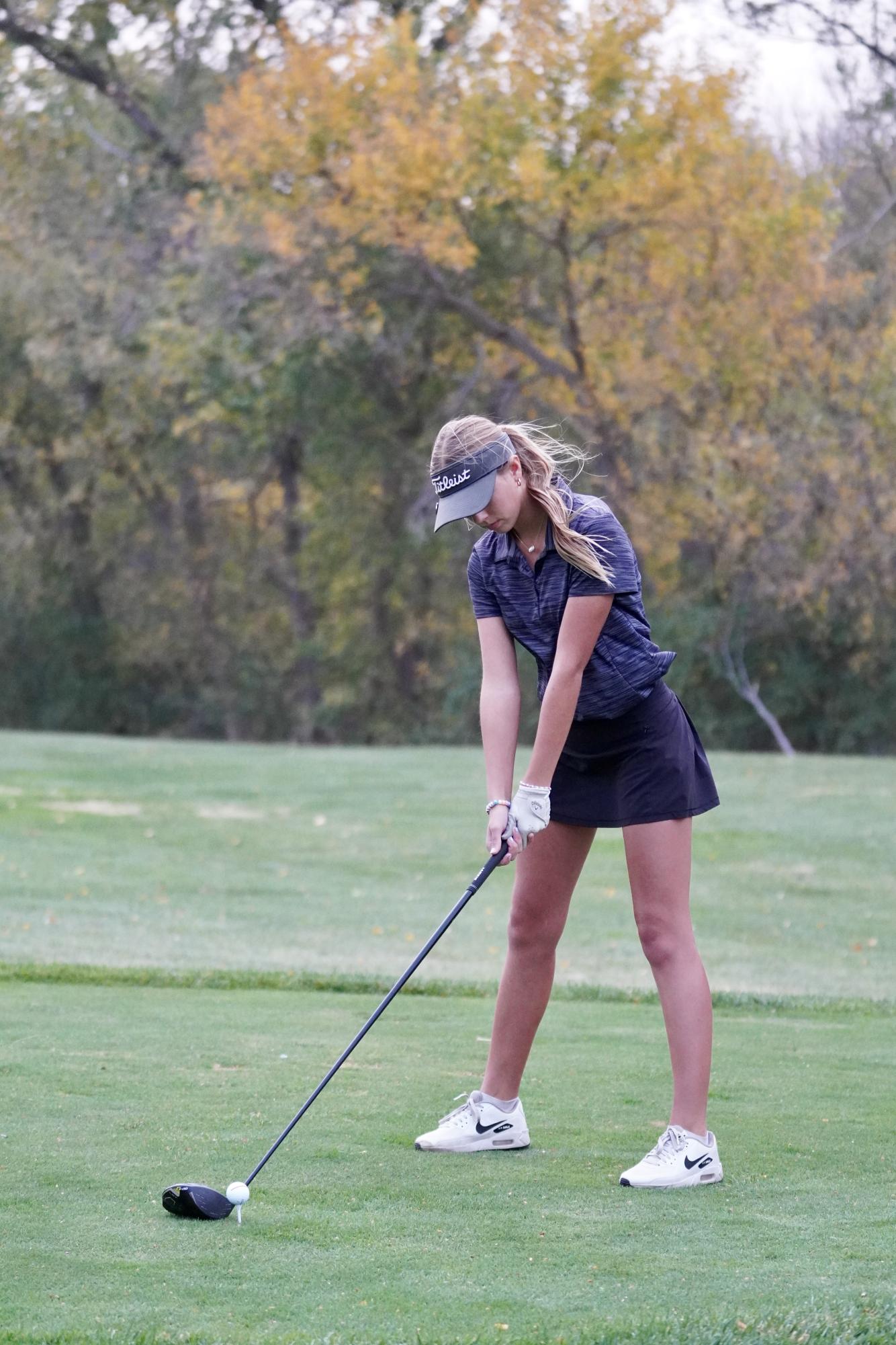 Junior Naomi Koontz tees off at a golf tournament