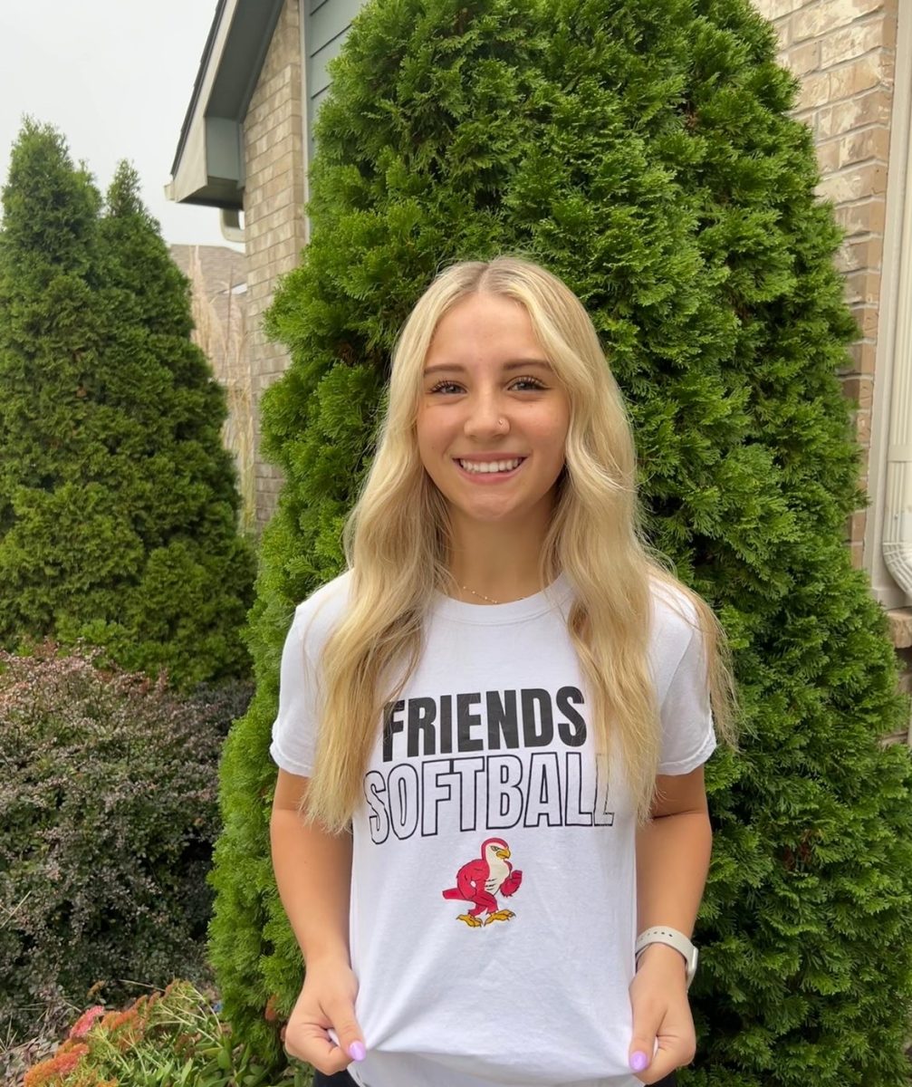 Senior Kinlee Unruh poses for a picture wearing her college apparel.